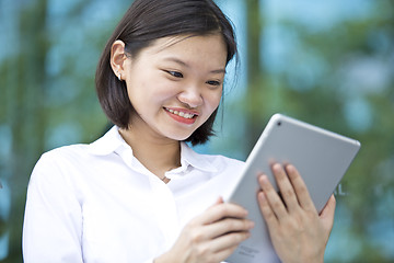 Image showing Asian young female executive using tablet
