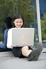 Image showing Asian young female executive using laptop