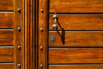 Image showing  knocker in a   closed wood door olgiate olona varese italy