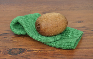 Image showing Darning egg with hand-knitted sock