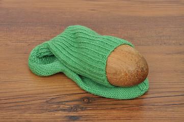 Image showing Darning egg with hand-knitted sock