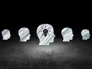 Image showing Business concept:  head with light bulb icon in grunge dark room