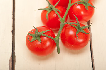 Image showing fresh cherry tomatoes on a cluster