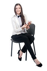 Image showing Pretty business lady with roubles sits on chair