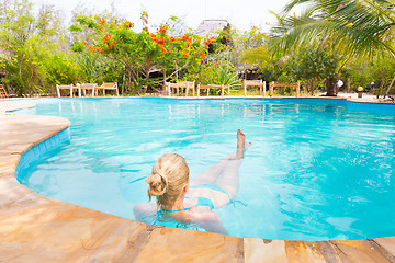 Image showing Caucasian lady floating in swimming pool.