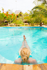 Image showing Caucasian lady floating in swimming pool.