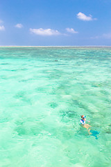 Image showing woman snorkeling in turquoise blue sea.