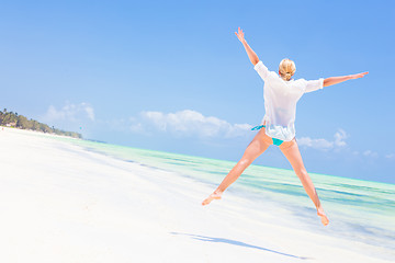 Image showing Beautiful Girl Jumping on Tropical Beach.