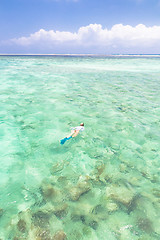 Image showing woman snorkeling in turquoise blue sea.