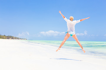 Image showing Beautiful Girl Jumping on Tropical Beach.