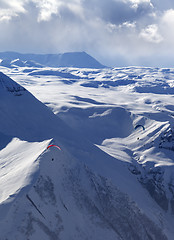 Image showing Speed flying in winter evening mountains