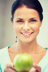 Image showing lovely housewife with green apple