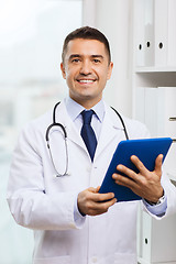 Image showing smiling male doctor in white coat with tablet pc