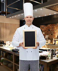 Image showing happy male chef cook holding blank menu board