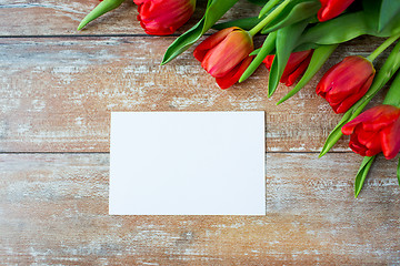 Image showing close up of red tulips and blank paper or letter