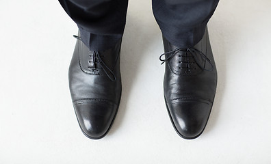 Image showing close up of man legs in elegant shoes with laces