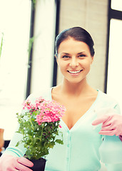 Image showing lovely housewife with flower