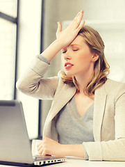 Image showing businesswoman holding her head with hand