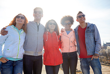 Image showing happy teenage friends in shades hugging on street