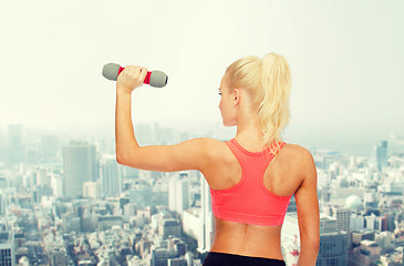 Image showing young sporty woman with light dumbbell