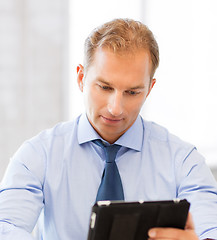 Image showing businessman with tablet pc in office