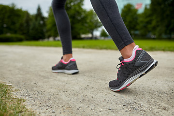 Image showing close up of woman feet running on track from back