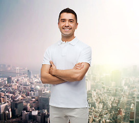 Image showing smiling man in white t-shirt over city background