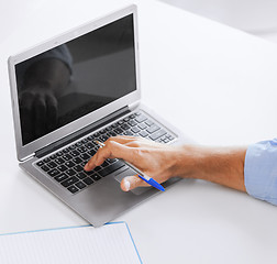 Image showing miling businessman working in office