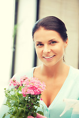 Image showing lovely housewife with flower