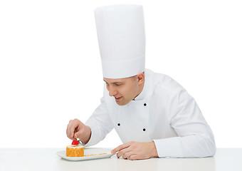 Image showing happy male chef cook decorating dessert