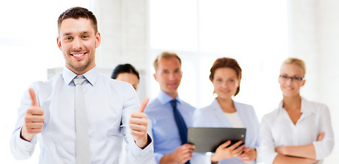 Image showing businessman in office showign thumbs up