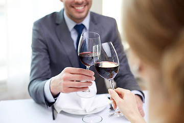 Image showing happy couple with glasses of wine at restaurant