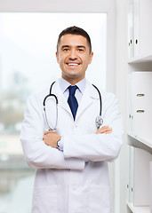 Image showing smiling doctor in white coat at medical office