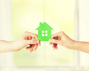 Image showing couple hands holding green house