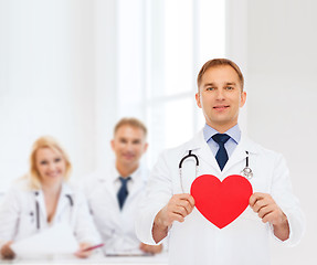 Image showing smiling male doctor with red heart and stethoscope