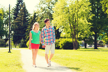 Image showing smiling couple walking in park