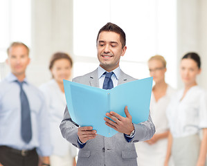 Image showing happy businessman with open folder