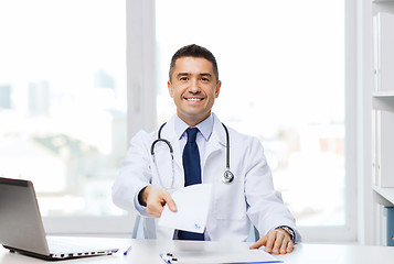 Image showing happy doctor with prescription and laptop