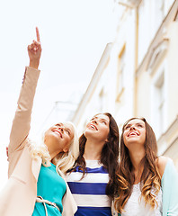 Image showing beautiful girls looking at something in the city