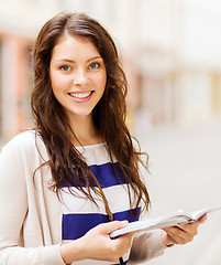 Image showing girl looking into tourist book in the city