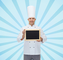 Image showing happy male chef cook holding blank menu board