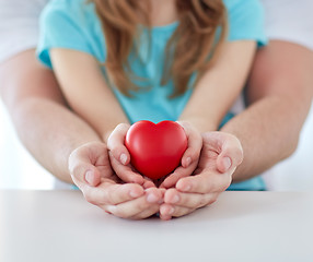 Image showing close up of man and girl holding red heart shape