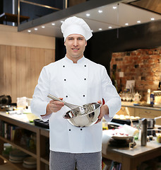 Image showing happy male chef cook whipping something with whisk