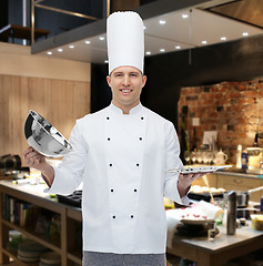 Image showing happy male chef cook opening cloche