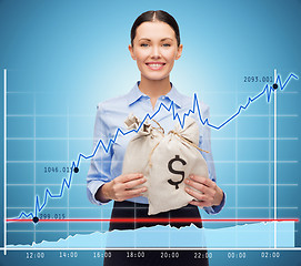 Image showing businesswoman holding money bags with euro