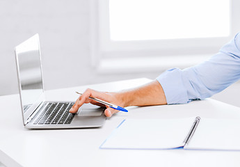 Image showing smiling businessman working in office