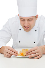 Image showing happy male chef cook decorating dessert