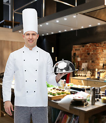 Image showing happy male chef cook holding cloche