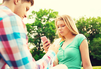 Image showing couple with smartphones in park