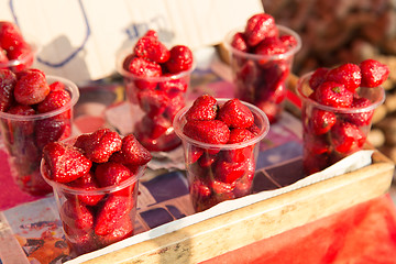 Image showing strawberry in plastic cups at street market